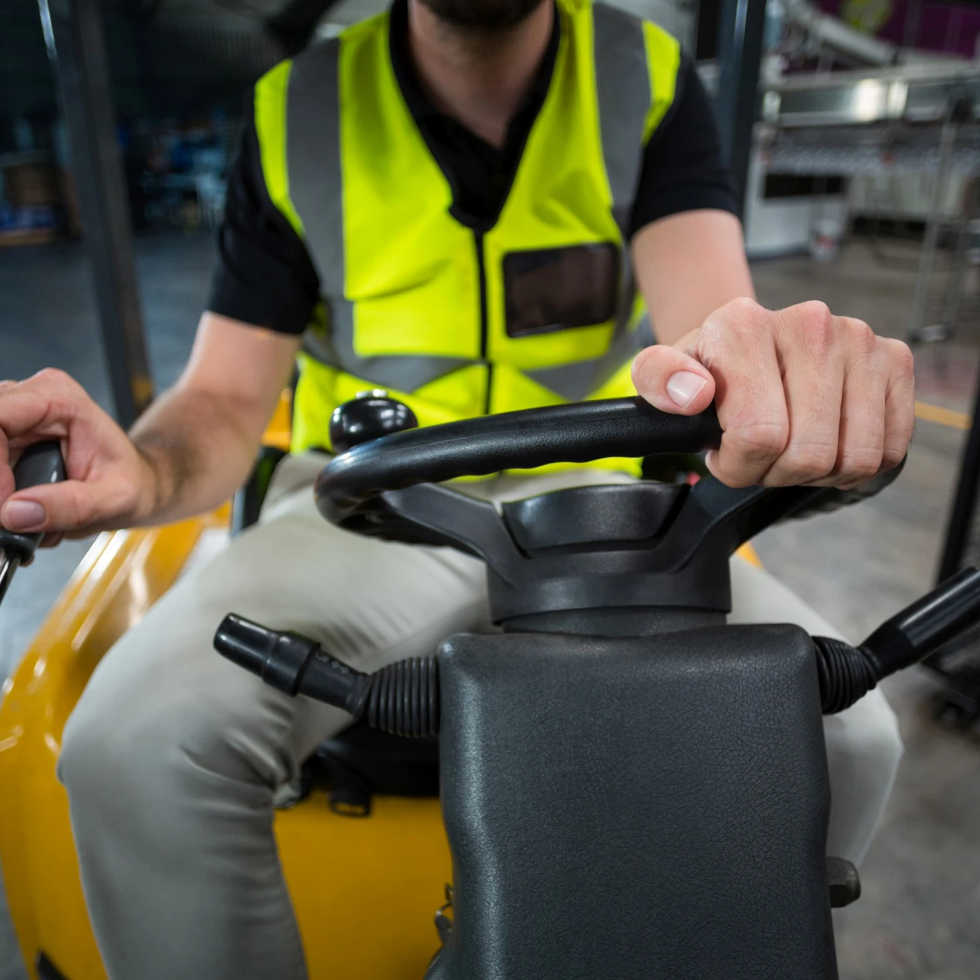 Factory worker driving forklift in factory